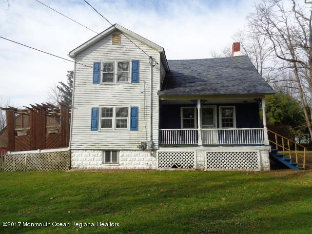 90 Jackson Mills Road Freehold, NJ 07728 - Photo 2 of 18 a front view of a house with a garden