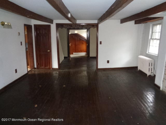 90 Jackson Mills Road Freehold, NJ 07728 - Photo 6 of 18 an empty room with wooden floor and windows