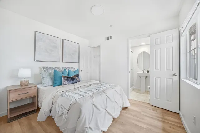 a bedroom with a bed and a painting on the wall