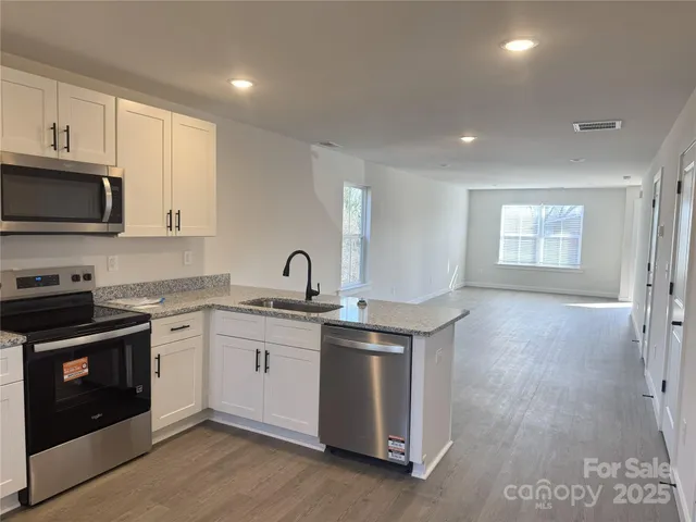a kitchen with a sink stove and microwave