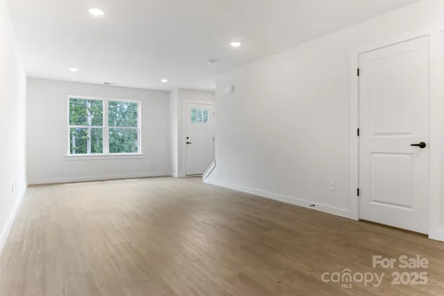 an empty room with windows and closet