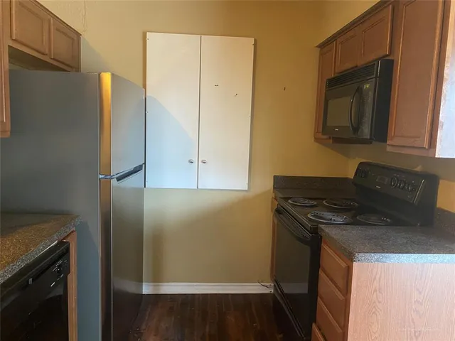 a kitchen with a sink and a refrigerator