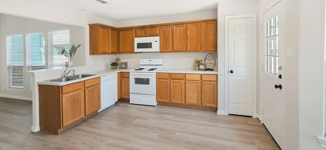 a view of a kitchen and dining room with furniture window and wooden floor