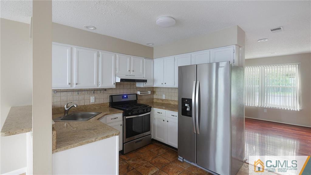 201 Nebula Road Piscataway, NJ 08854 - Photo 13 of 27 a kitchen with stainless steel appliances granite countertop a refrigerator stove and sink