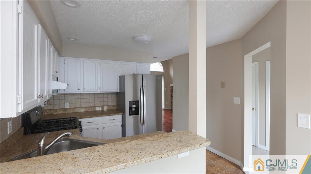 201 Nebula Road Piscataway, NJ 08854 - Photo 14 of 27 a kitchen with stainless steel appliances granite countertop a refrigerator and a sink