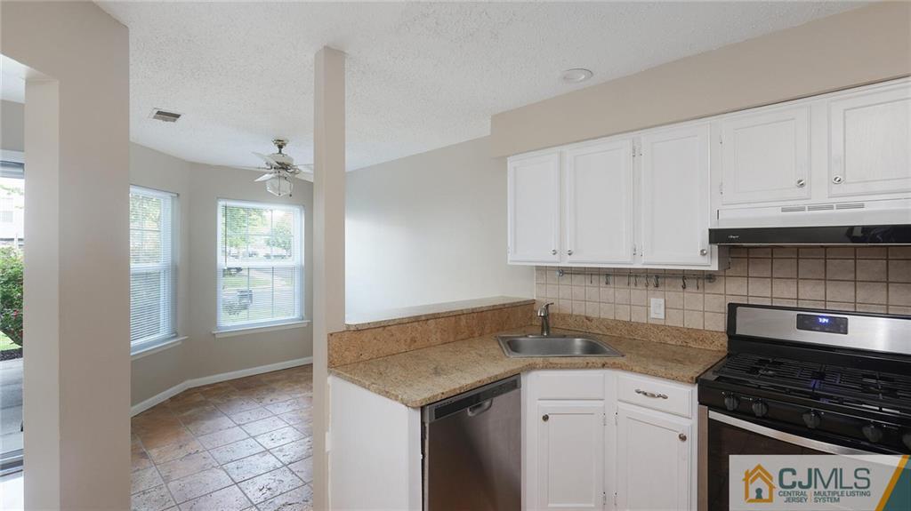 201 Nebula Road Piscataway, NJ 08854 - Photo 15 of 27 a kitchen with granite countertop a sink stove and cabinets