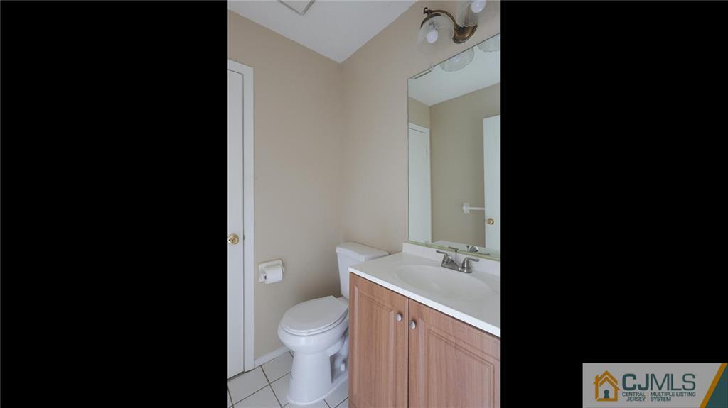 201 Nebula Road Piscataway, NJ 08854 - Photo 16 of 27 a bathroom with a granite countertop toilet a sink and a mirror