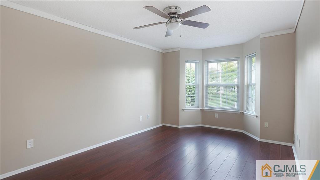 201 Nebula Road Piscataway, NJ 08854 - Photo 17 of 27 an empty room with wooden floor fan and windows