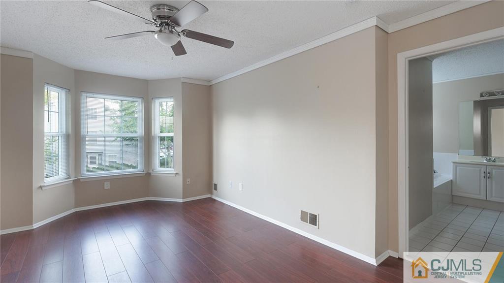 201 Nebula Road Piscataway, NJ 08854 - Photo 18 of 27 a view of an empty room with wooden floor and a window