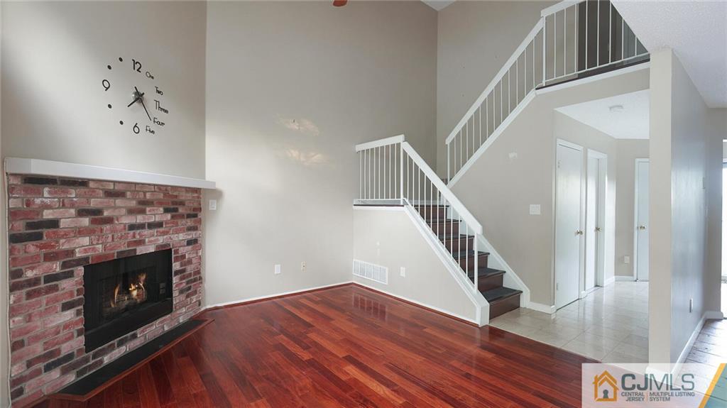 201 Nebula Road Piscataway, NJ 08854 - Photo 7 of 27 a view of a livingroom with wooden floor and a fireplace