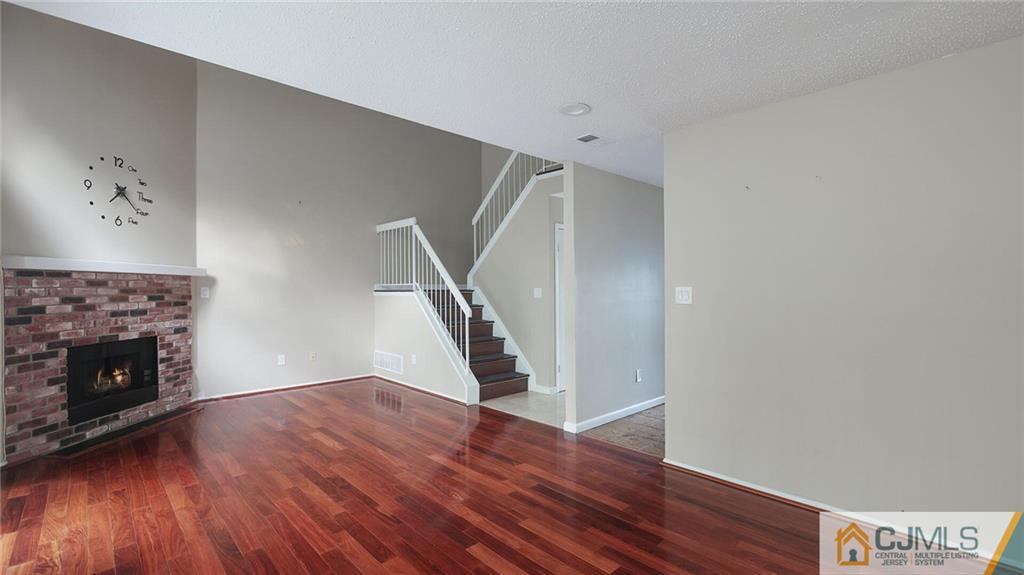 201 Nebula Road Piscataway, NJ 08854 - Photo 9 of 27 a view of an empty room with wooden floor fireplace and a window