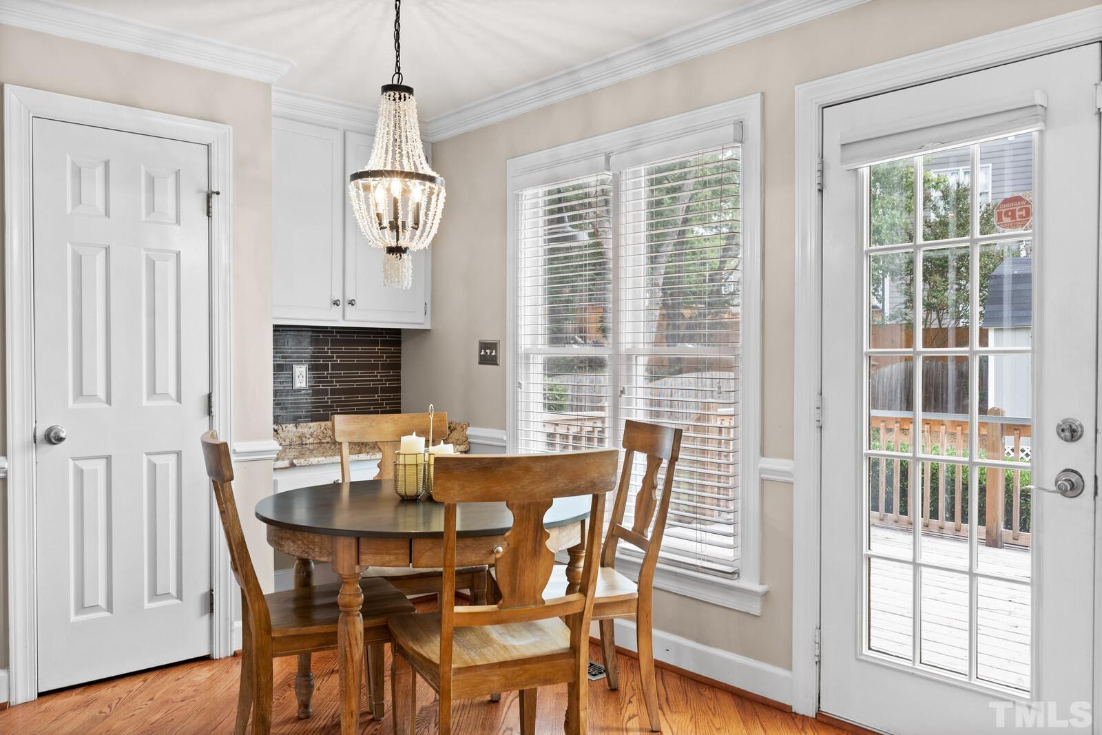 9100 Dawnshire Road Raleigh, NC 27615 - Photo 12 of 30 a view of a dining room with furniture window and wooden floor