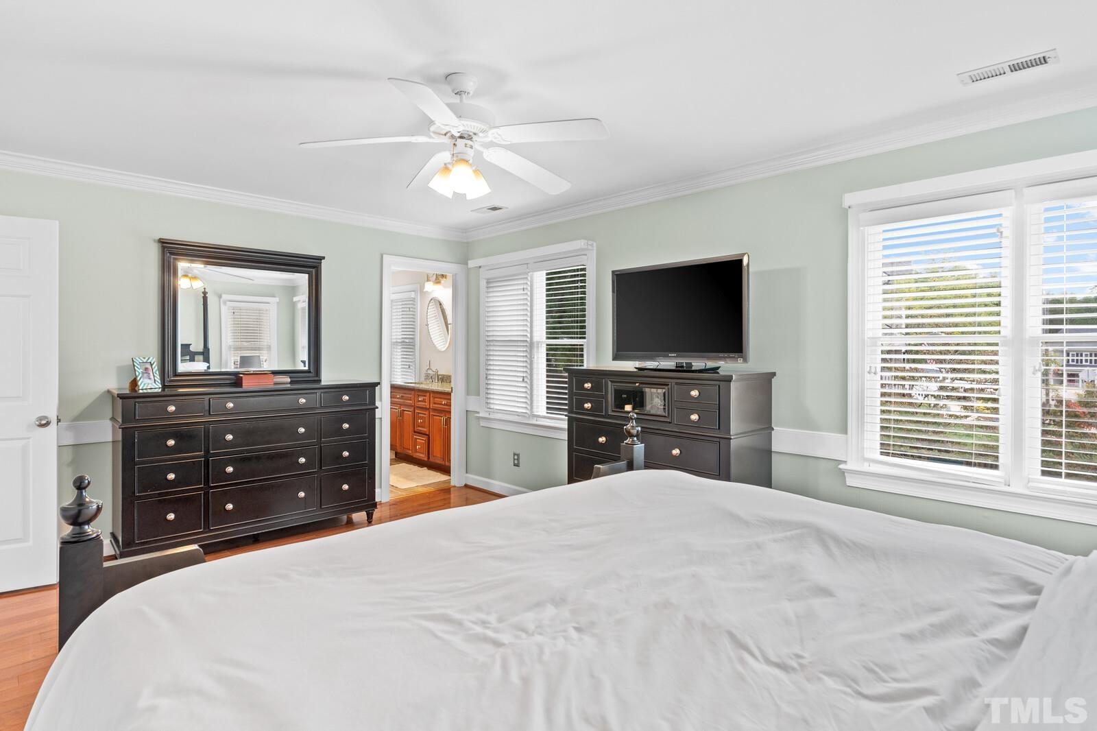 9100 Dawnshire Road Raleigh, NC 27615 - Photo 14 of 30 a bedroom with a bed and a flat screen tv