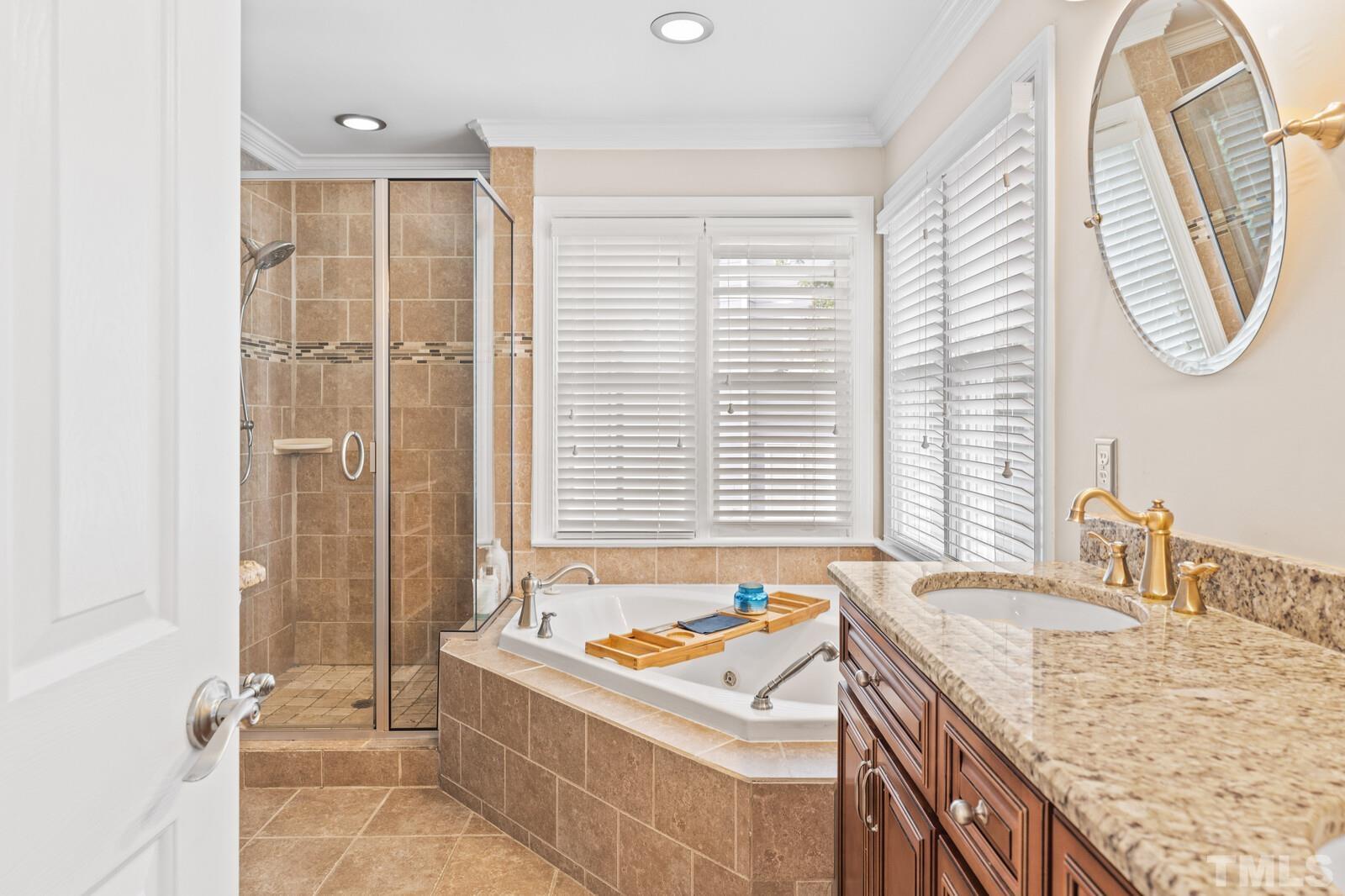 9100 Dawnshire Road Raleigh, NC 27615 - Photo 15 of 30 a bathroom with a granite countertop sink a toilet and a bathtub