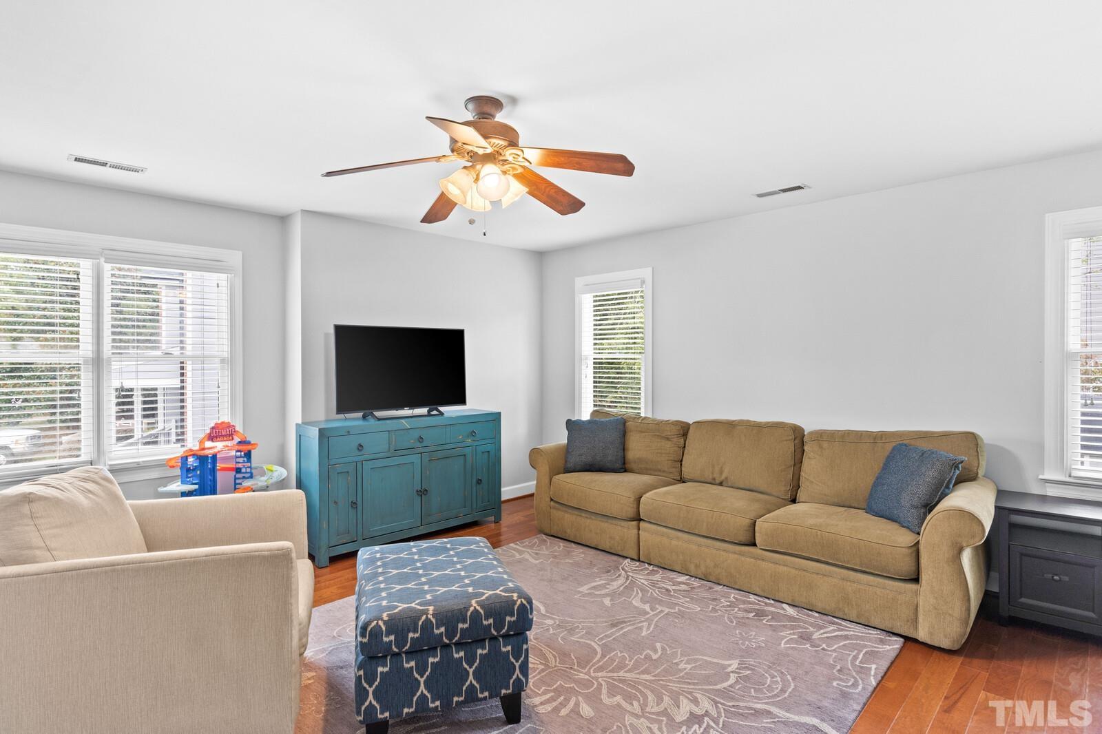 9100 Dawnshire Road Raleigh, NC 27615 - Photo 18 of 30 a living room with furniture and a flat screen tv