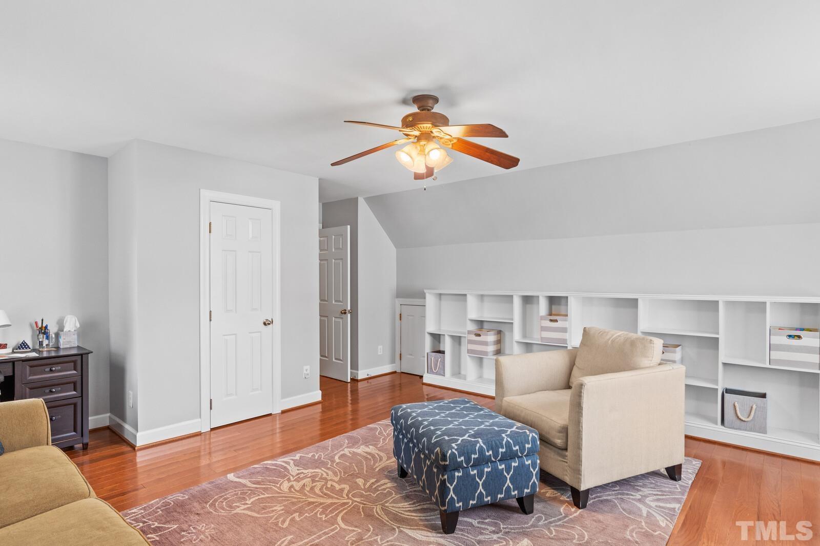 9100 Dawnshire Road Raleigh, NC 27615 - Photo 20 of 30 a living room with furniture a rug and a chandelier
