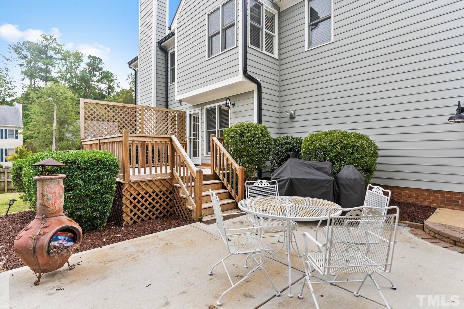 9100 Dawnshire Road Raleigh, NC 27615 - Photo 22 of 30 a view of a patio with table and chairs and potted plants