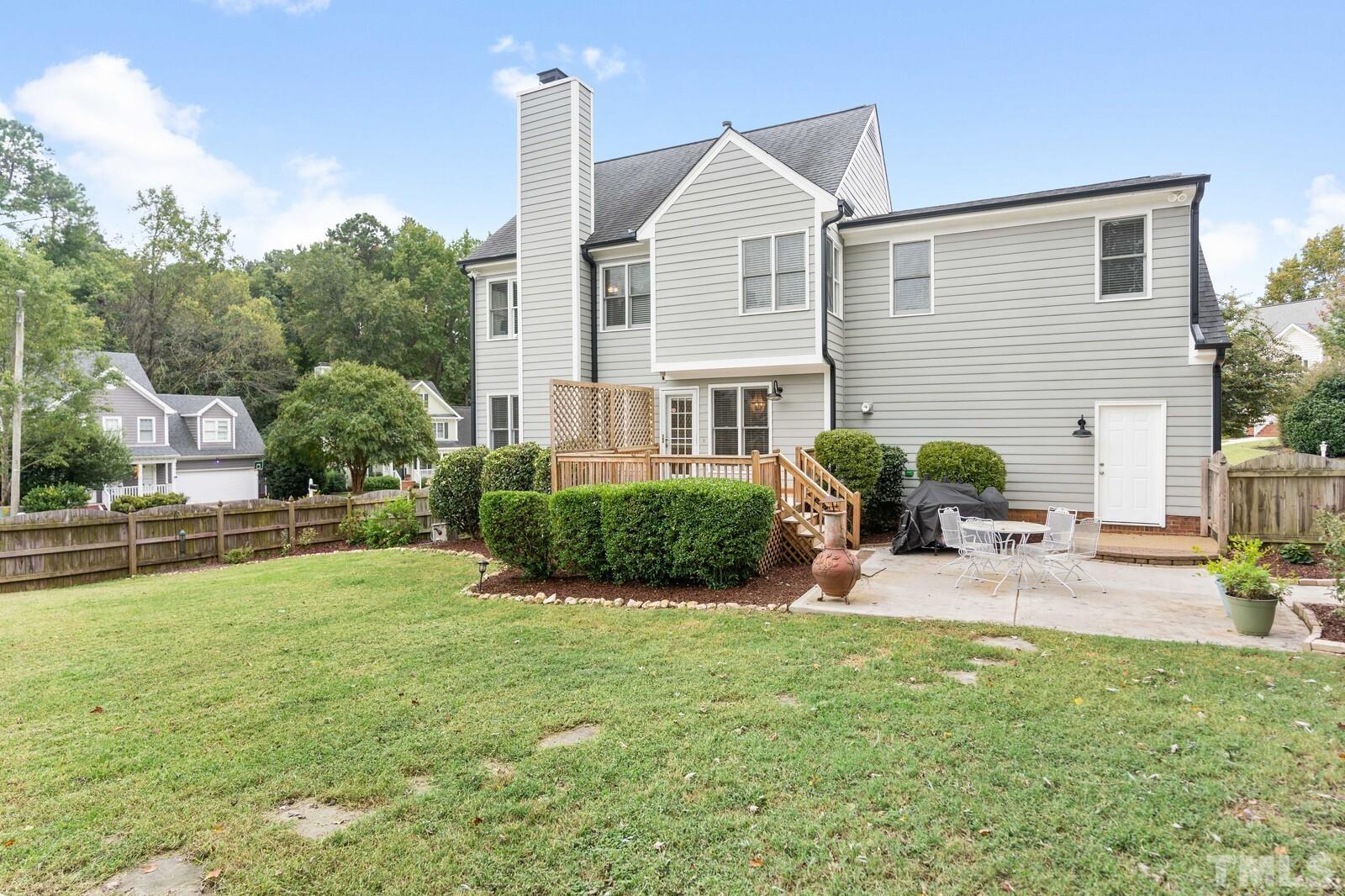 9100 Dawnshire Road Raleigh, NC 27615 - Photo 25 of 30 a view of a house with a patio and a yard
