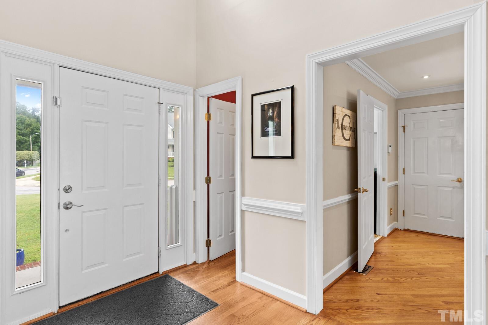 9100 Dawnshire Road Raleigh, NC 27615 - Photo 4 of 30 a view of a hallway with wooden floor and closet