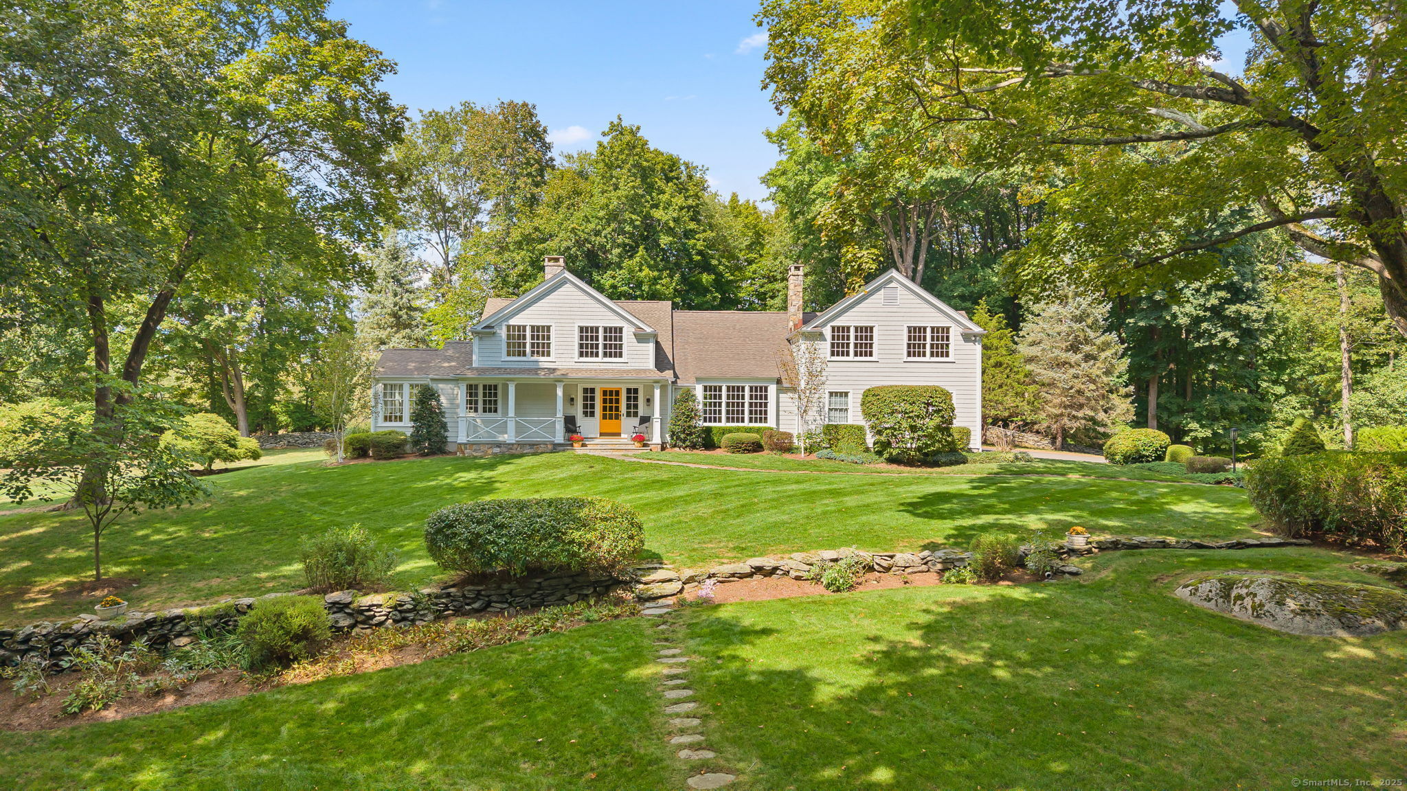 a front view of a house with a garden