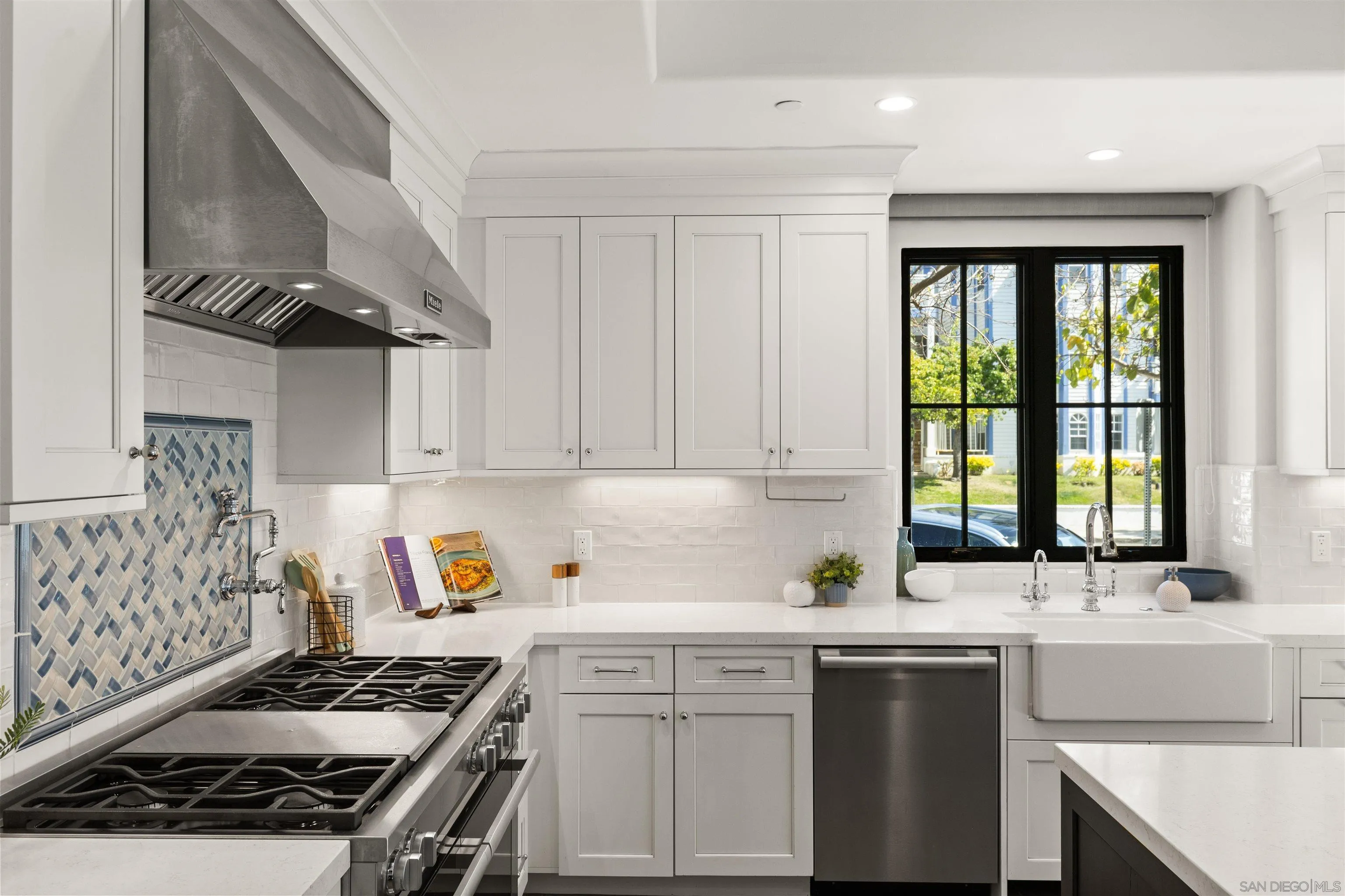 708 Silver Street La Jolla, CA 92037 - Photo 15 of 44 a kitchen with a sink stove top oven and cabinets