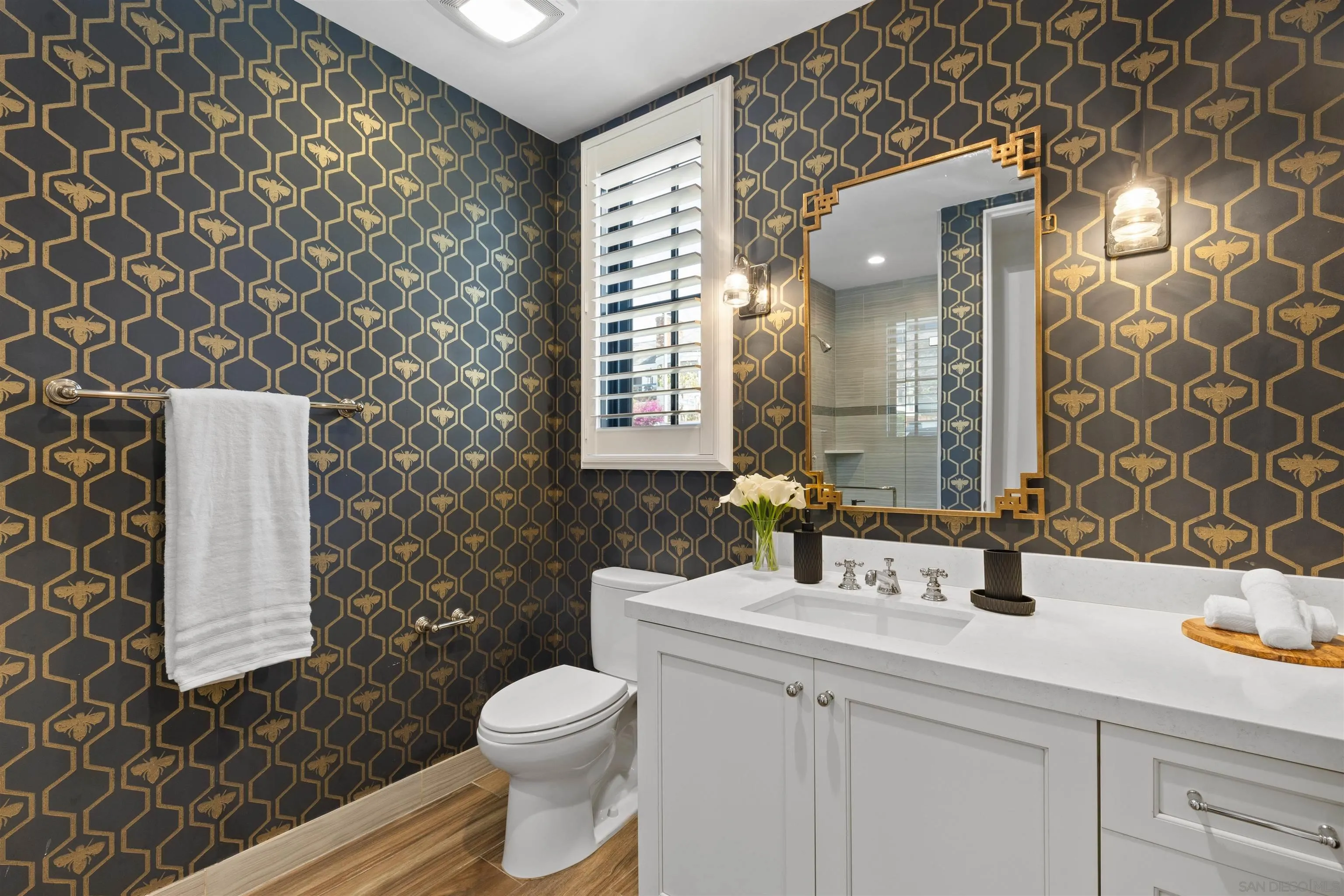 708 Silver Street La Jolla, CA 92037 - Photo 22 of 44 a bathroom with a sink a toilet and mirror