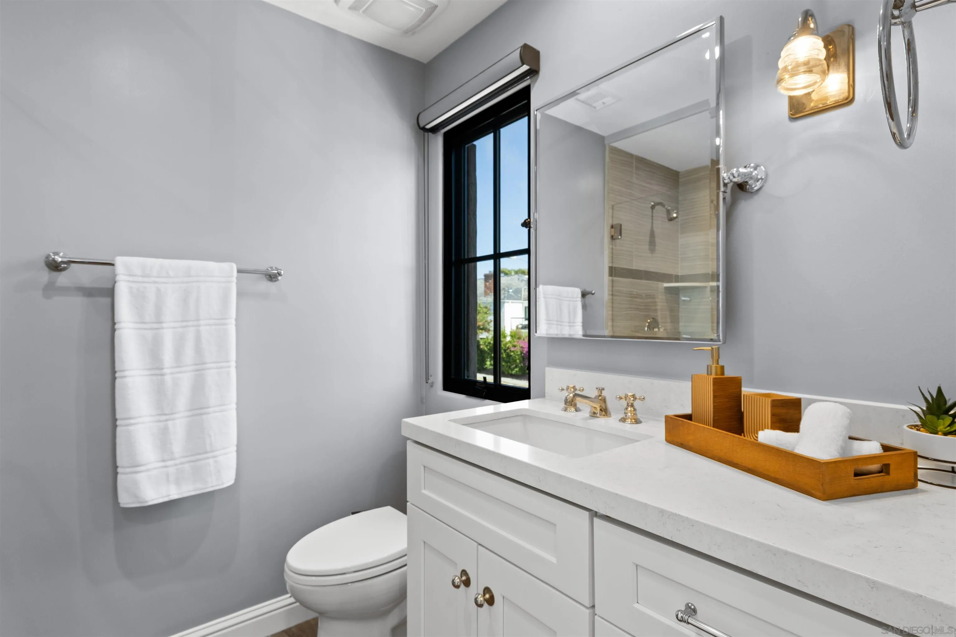 708 Silver Street La Jolla, CA 92037 - Photo 35 of 44 a bathroom with a sink a toilet and a mirror