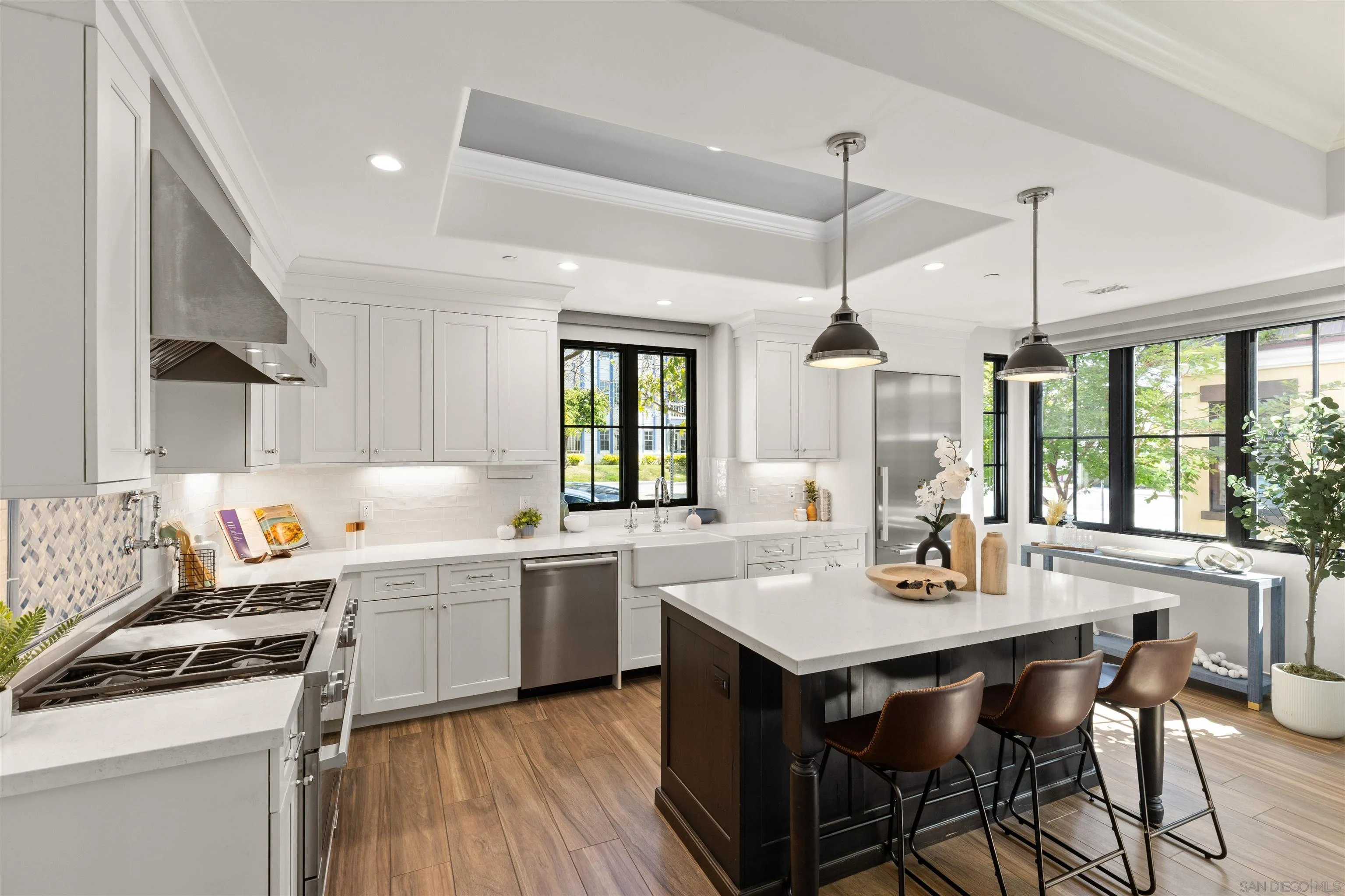 708 Silver Street La Jolla, CA 92037 - Photo 4 of 44 a kitchen with a stove a sink a dining table and chairs