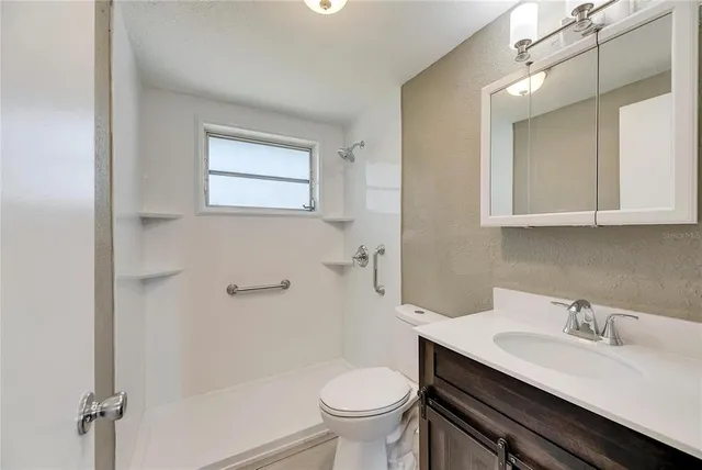 a bathroom with a sink toilet and a mirror