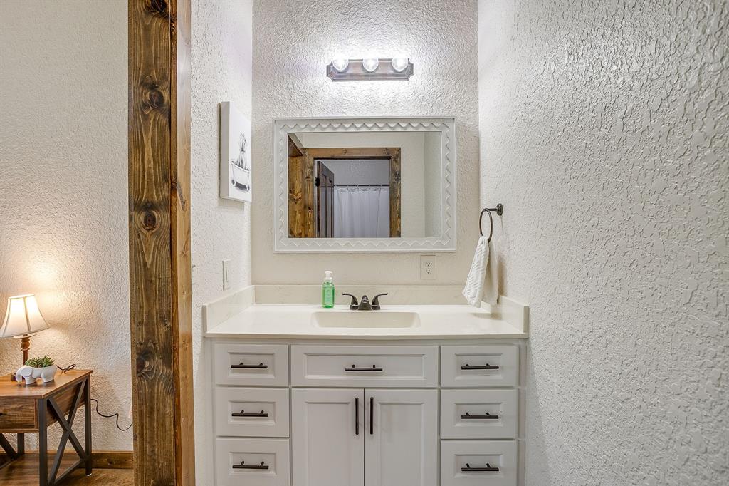 201 Curry Road Waxahachie, TX 75167 - Photo 21 of 40 a bathroom with a sink and a mirror