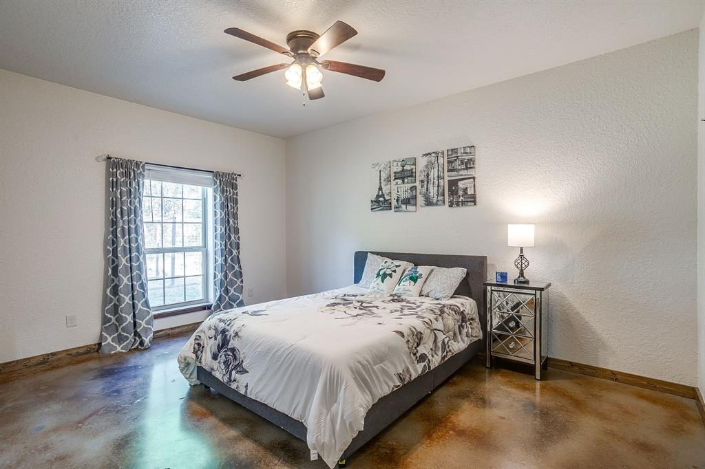 201 Curry Road Waxahachie, TX 75167 - Photo 23 of 40 a bedroom with a bed chandelier and a window