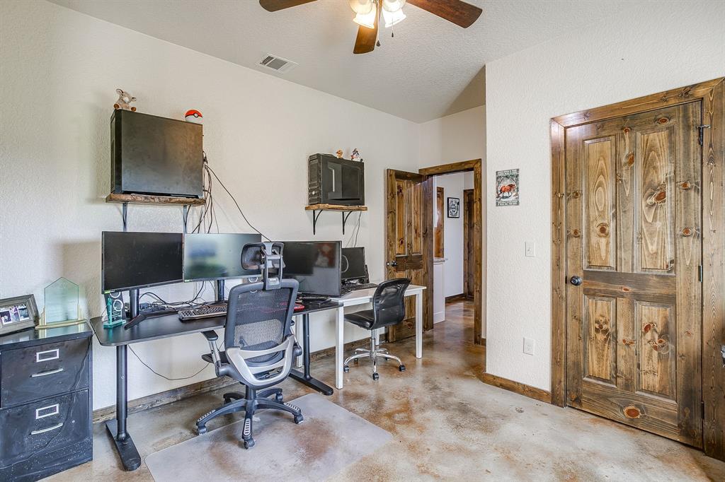 201 Curry Road Waxahachie, TX 75167 - Photo 24 of 40 a view of a workspace with furniture and a window