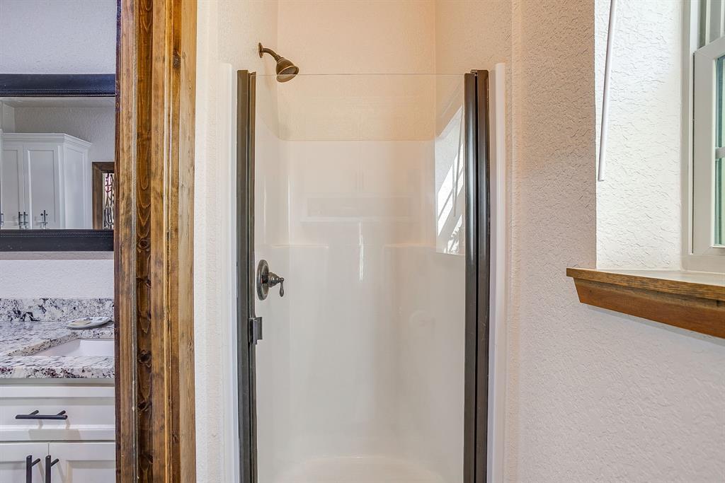 201 Curry Road Waxahachie, TX 75167 - Photo 26 of 40 a bathroom with a shower and a mirror