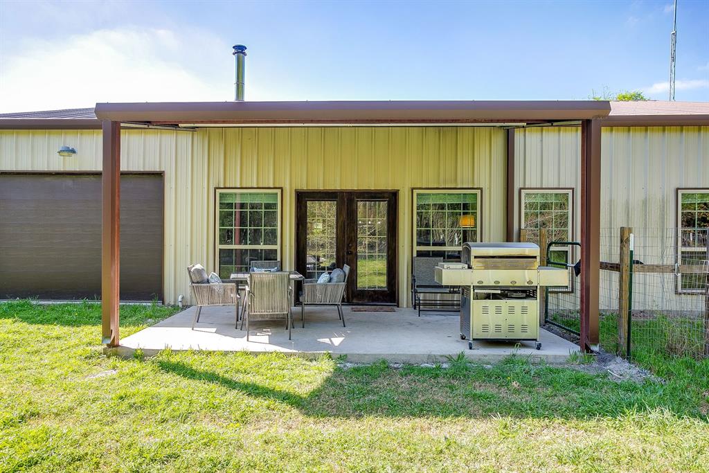 201 Curry Road Waxahachie, TX 75167 - Photo 30 of 40 a view of a patio with table and chairs and potted plants
