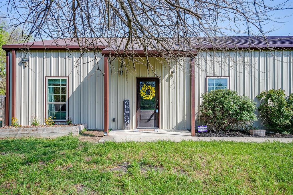 201 Curry Road Waxahachie, TX 75167 - Photo 3 of 40 a view of a house with a small yard and wooden fence