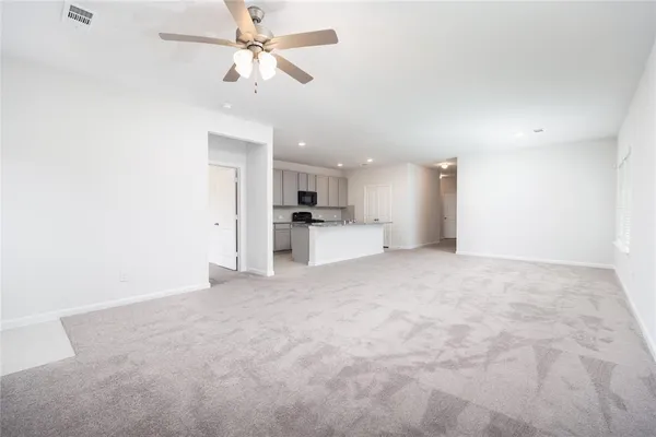 a view of a kitchen with a sink and a refrigerator