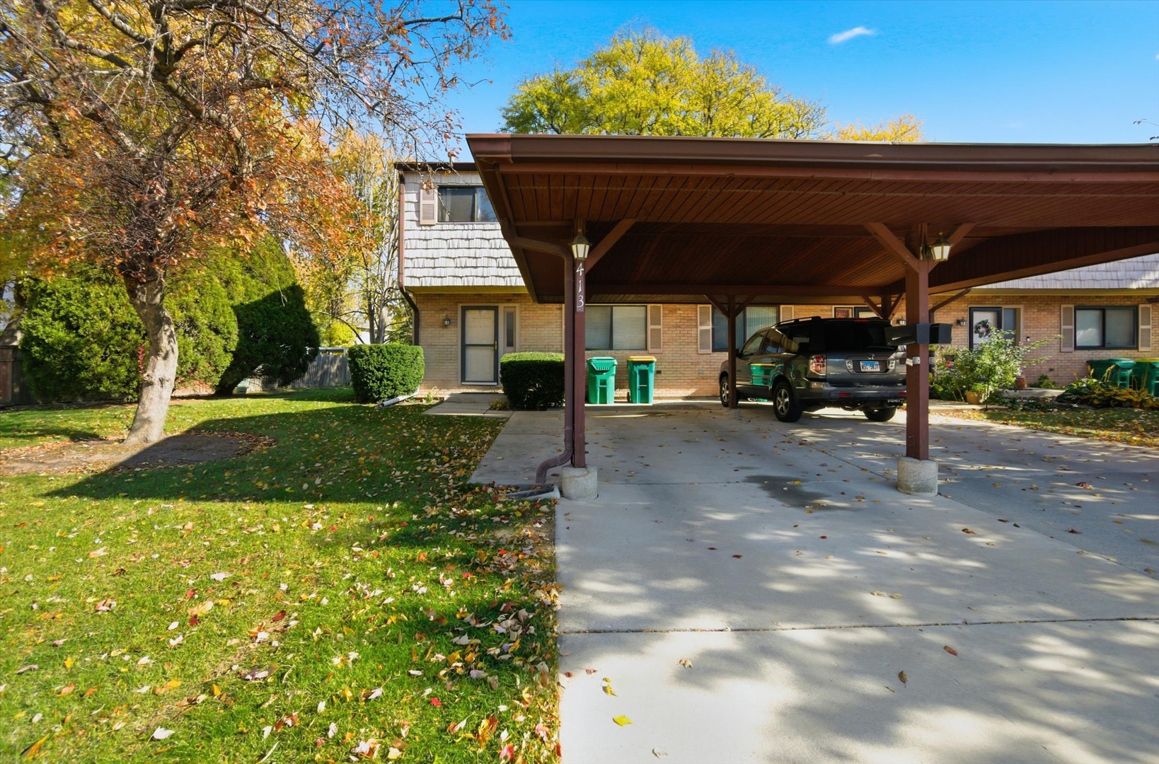 a view of patio with table and chairs under an umbrella