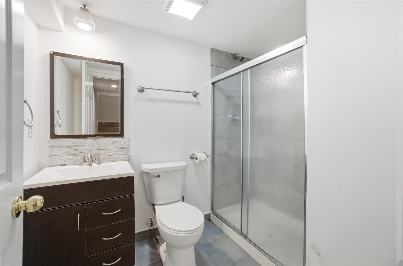 413 Buffalo Trail Wheeling, IL 60090 - Photo 17 of 29 a bathroom with a sink toilet and shower