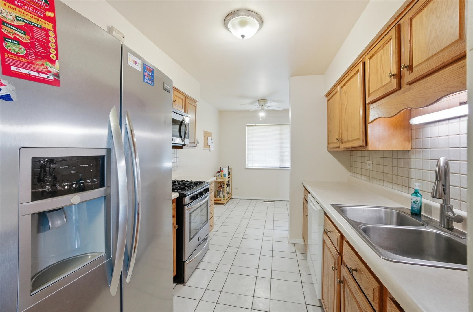 413 Buffalo Trail Wheeling, IL 60090 - Photo 6 of 29 a kitchen with stainless steel appliances granite countertop a refrigerator and a sink