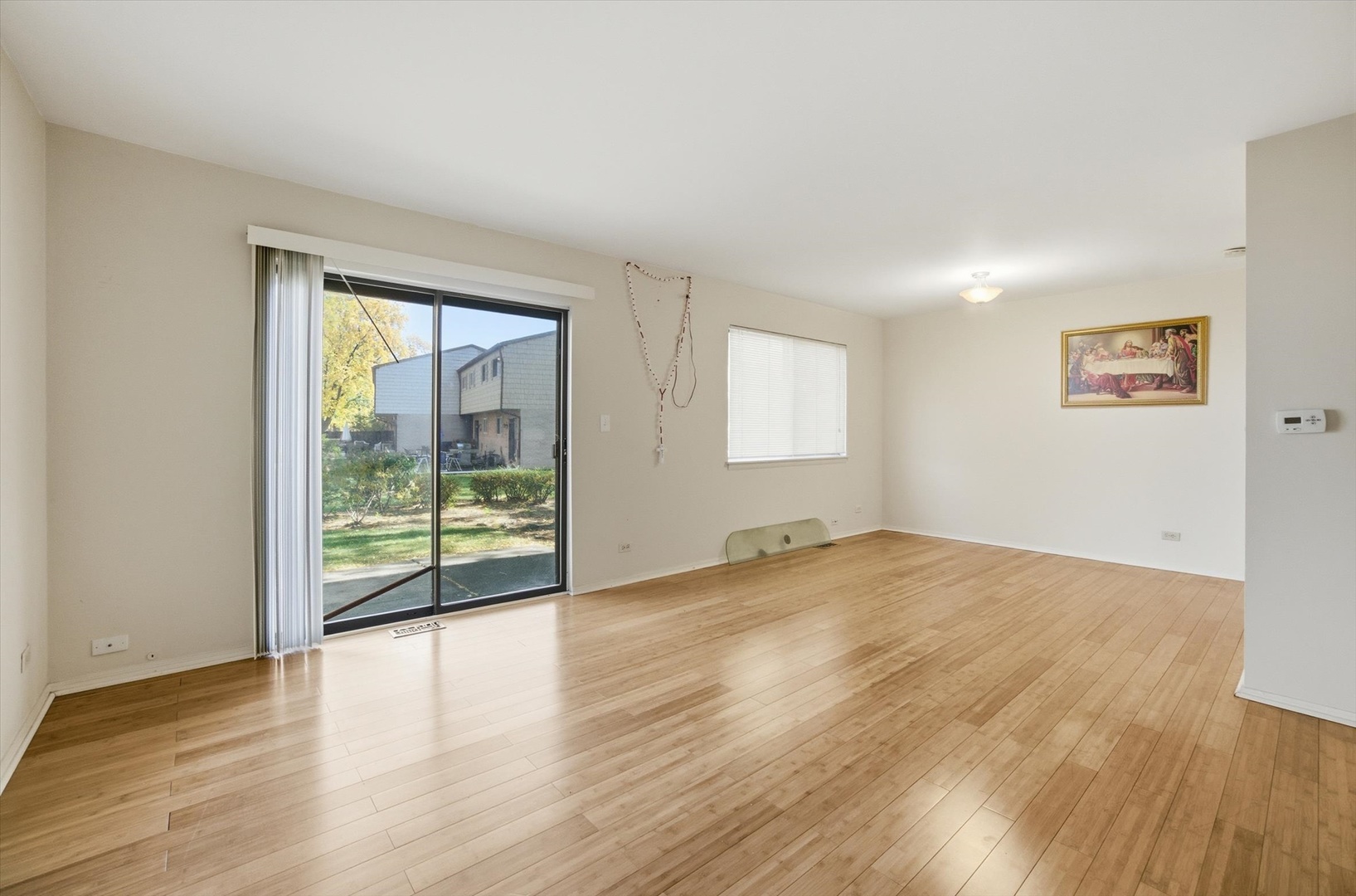 413 Buffalo Trail Wheeling, IL 60090 - Photo 9 of 29 an empty room with wooden floor and windows