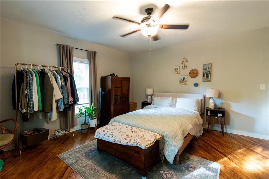 702 Radford Street Monroe, GA 30655 - Photo 16 of 49 a bedroom with a bed closet and flat tv screen