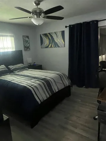 a bedroom with a bed dresser and a window