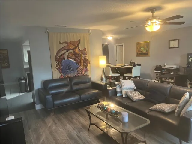a living room with furniture and wooden floor