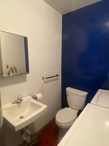 141 South Lakeshore Drive, Unit B1 Racine, WI 53403 - Photo 11 of 26 a bathroom with a toilet a sink and mirror