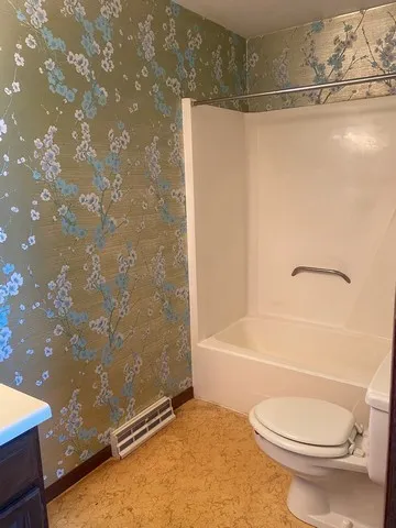 an empty room with windows and closet