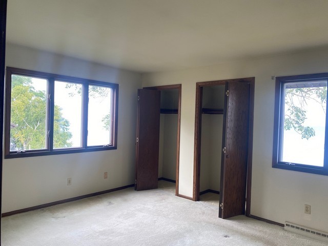 141 South Lakeshore Drive, Unit B1 Racine, WI 53403 - Photo 25 of 26 an empty room with windows and closet