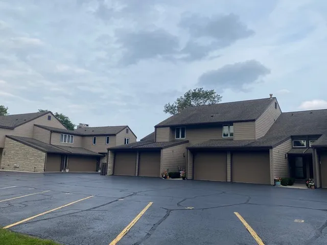 a view of a house with a garage and a roof