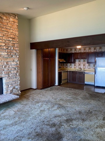 141 South Lakeshore Drive, Unit B1 Racine, WI 53403 - Photo 10 of 26 a view of a kitchen with a sink and a refrigerator