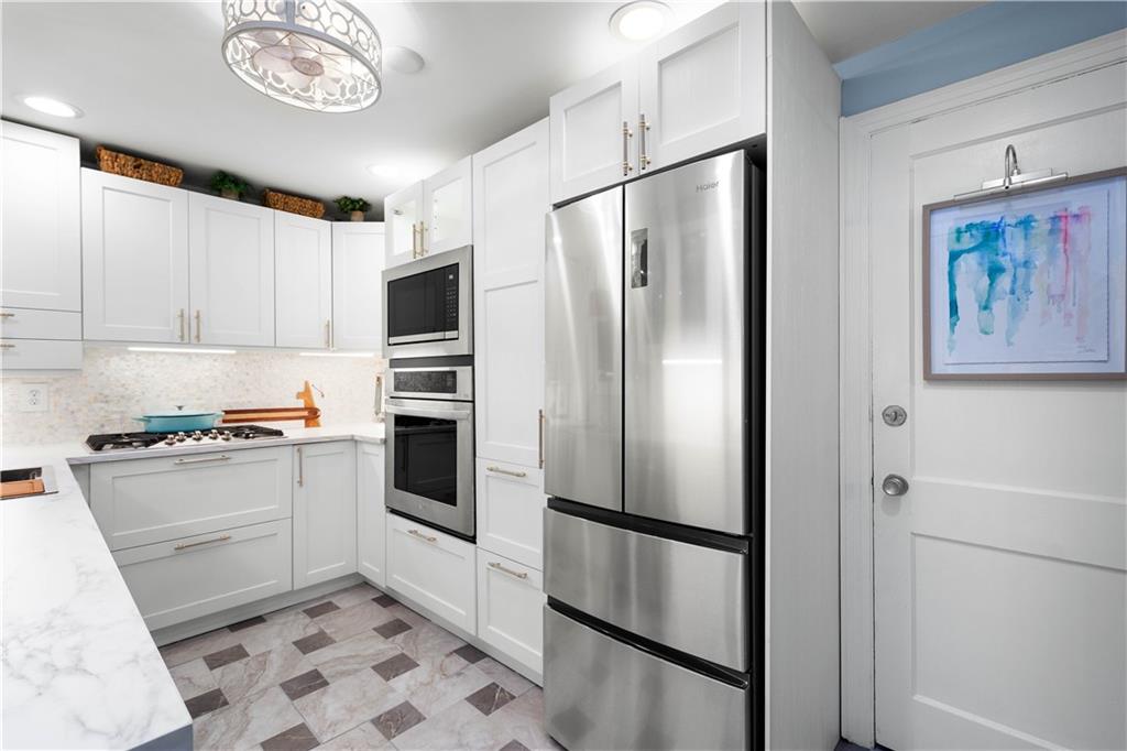 112 Locust Lane Pittsburgh, PA 15241 - Photo 11 of 38 a kitchen with stainless steel appliances and a refrigerator
