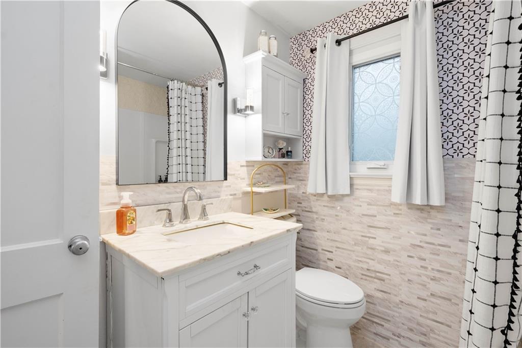 112 Locust Lane Pittsburgh, PA 15241 - Photo 17 of 38 a bathroom with a toilet sink and mirror